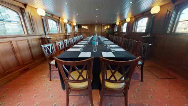 Elegant meeting room with long table, ideal for corporate events and discussions.