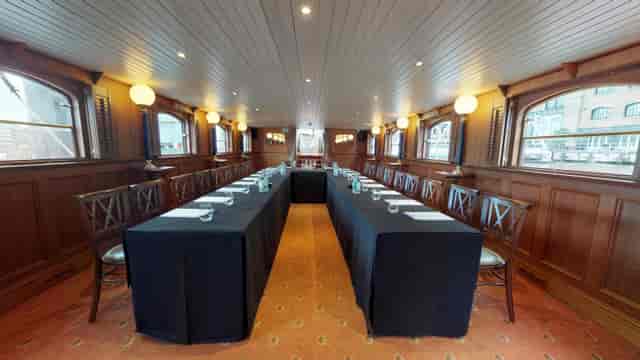 Elegant U-shaped meeting space on a boat, ideal for corporate retreats and gatherings.
