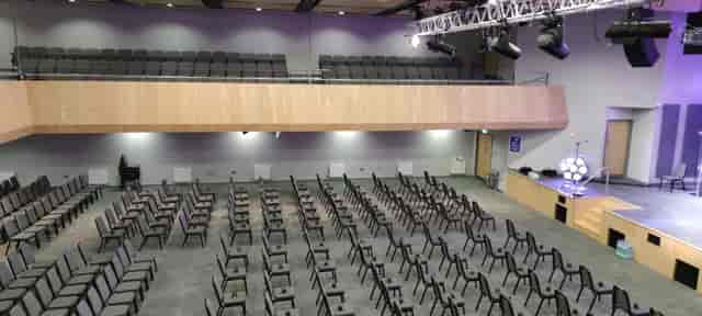 Spacious auditorium with empty chairs, ready for a conference presentation.