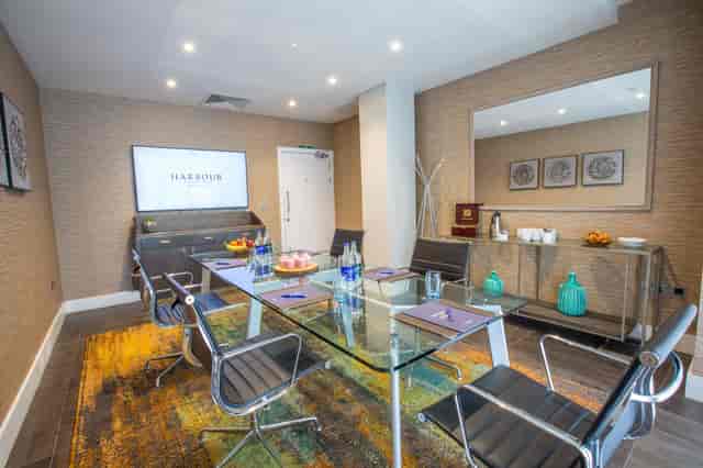 Modern meeting room in Guildford Harbour Hotel with glass table, ideal for conferences.