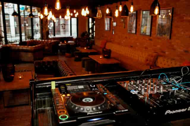 Stylish Wilfred's Lounge in Mayfair, perfect for events with cozy lighting and DJ setup.