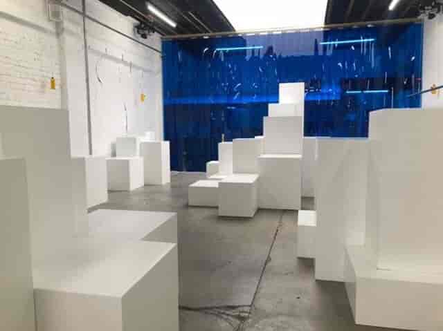 Modern minimalist event space with geometric seating near Victoria for creative gatherings.