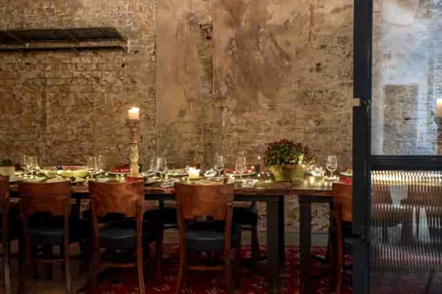Intimate private dining room with elegant table setting for corporate events or celebrations.