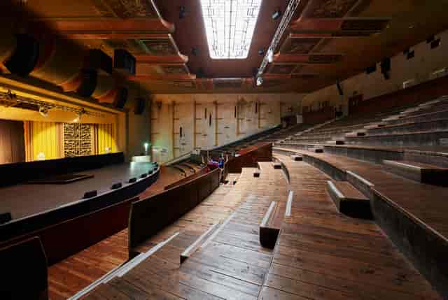 Spacious auditorium with tiered seating for conferences and presentations at EartH Theatre.
