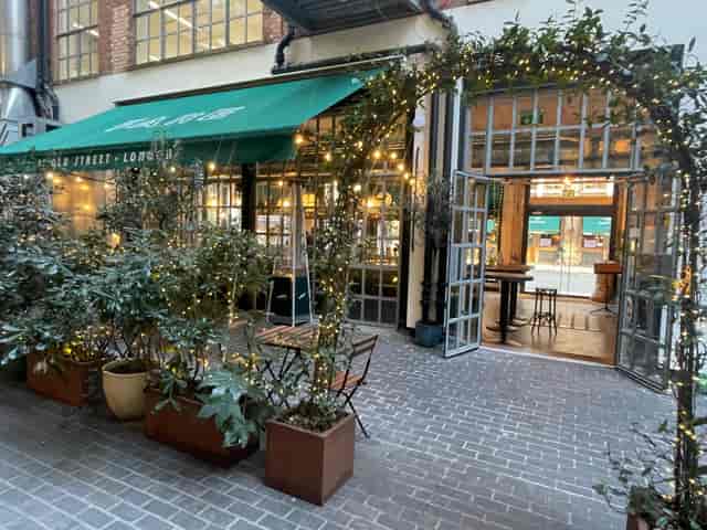 Charming outdoor venue with greenery for networking events at FARE Restaurant + Bar.