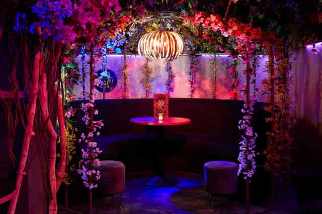 Vibrant Le Jardin event space in Le Fez with floral decor, ideal for cocktail parties.