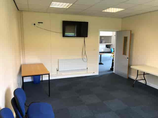 Conference room with table and chairs at DRAM Training Centre, ideal for meetings and events.