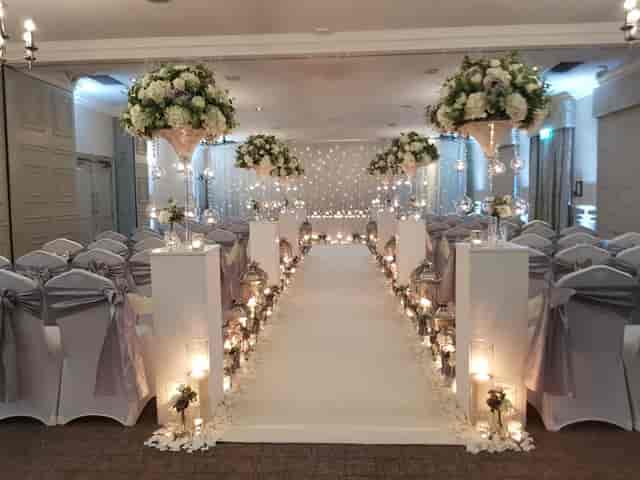 St Andrews Suite wedding setup with floral arrangements and elegant aisle decor.