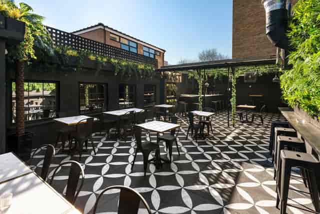 Stylish rooftop venue with greenery, ideal for networking events and social receptions.