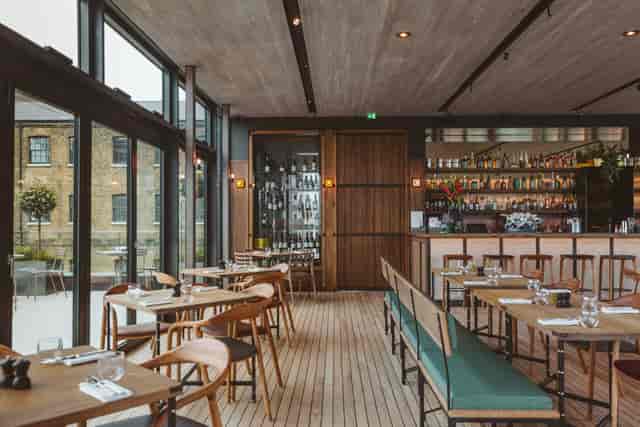 Contemporary dining room with large windows at The Lighterman, perfect for events.