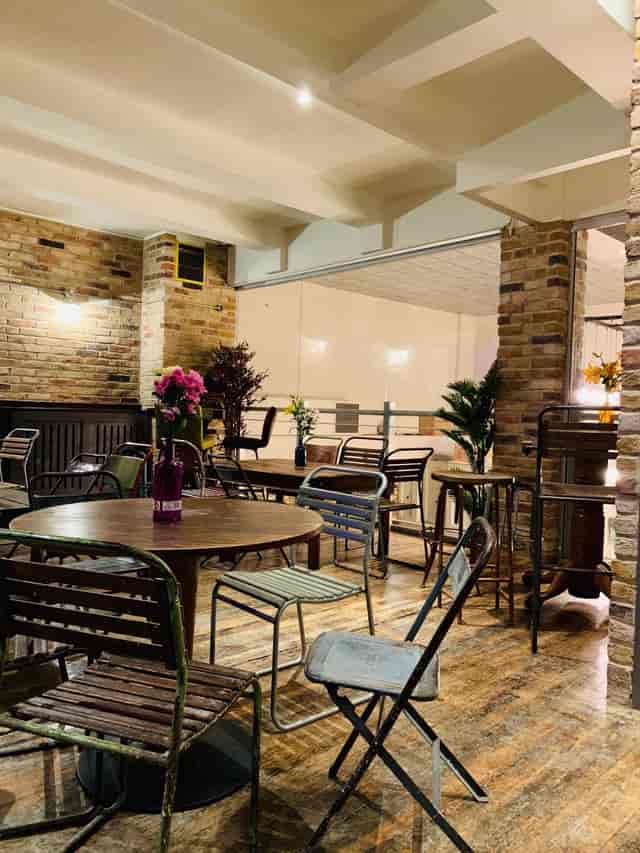 Versatile event space with wooden furniture, ideal for networking events and conferences.