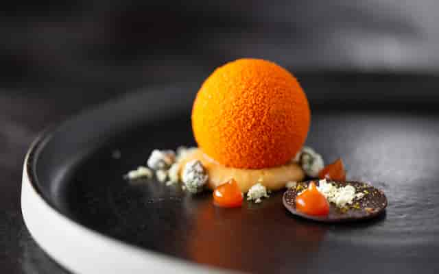 Elegant orange dessert sphere at Sequoia, Rockliffe Hall for upscale events.