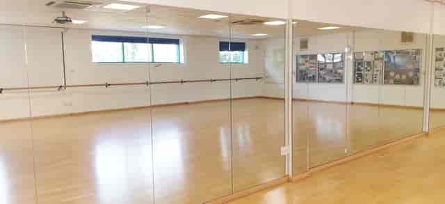 Dance studio with large mirrors, ideal for workshops and fitness events.