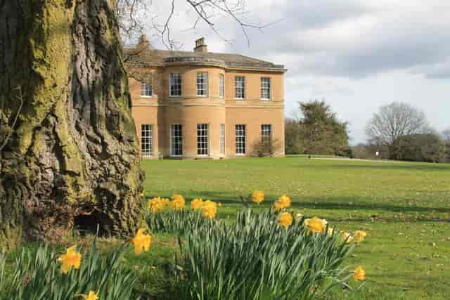 Historic Rudding Park Library venue with vibrant daffodils for outdoor weddings and events.