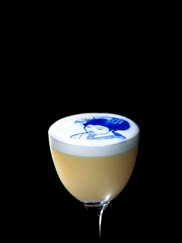Creative cocktail with frothy top at Gordon Ramsay's Lucky Cat, perfect for events.