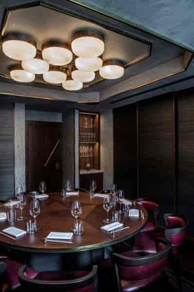 Sophisticated meeting room with round table for exclusive events by Gordon Ramsay.