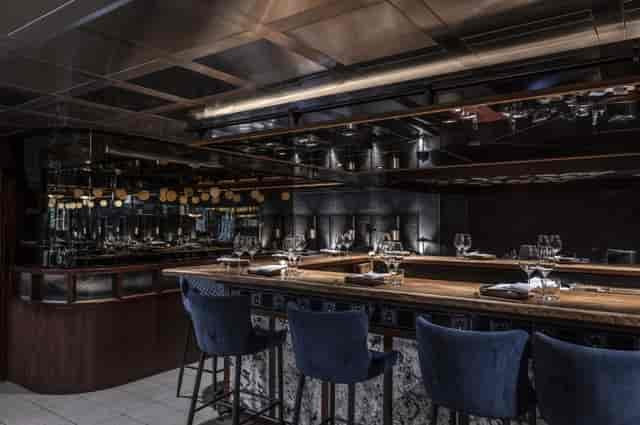 Sophisticated kitchen table at Lucky Cat by Gordon Ramsay for intimate gatherings and events.