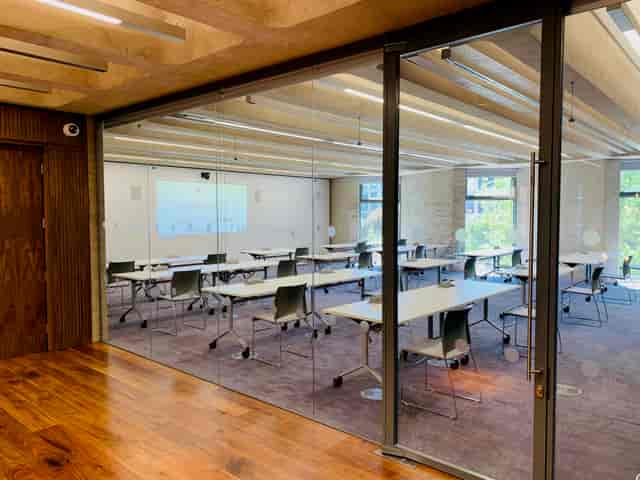 Modern Grosvenor Room with glass walls, ideal for corporate meetings and workshops.