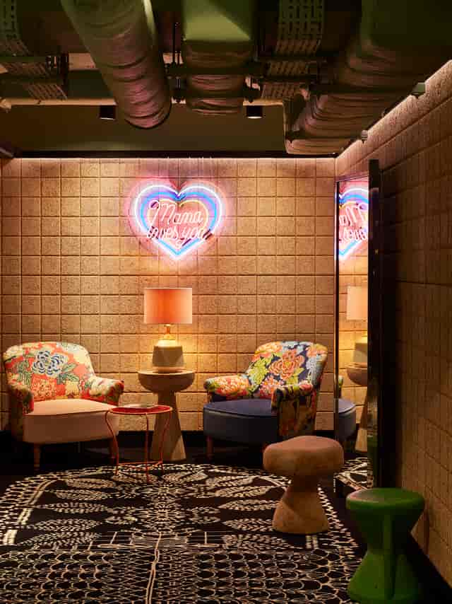 Cozy lounge at Mama Shelter London with vibrant floral chairs for networking events.