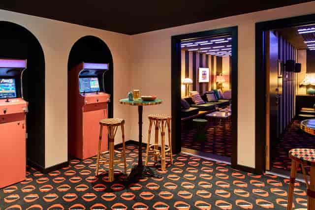 Vibrant Karaoke 2 event space in Mama Shelter London with retro arcade games.