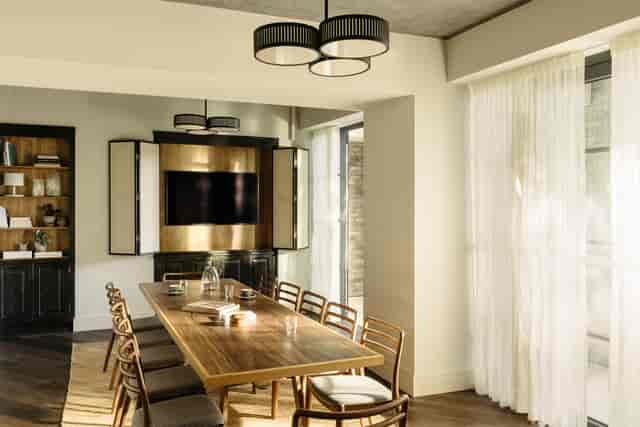Modern meeting room with large wooden table at The Hoxton Southwark for collaboration.