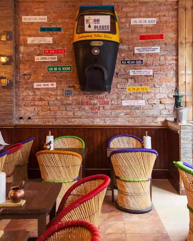Vibrant dining space with colorful chairs for casual meetings and events at Horn Please.
