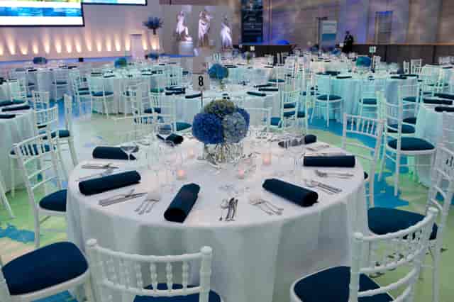 Elegant event space with blue flower centerpieces at National Maritime Museum.
