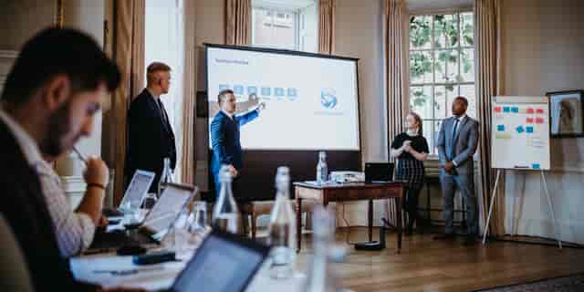 Professional meeting at Norwood Park Country House with engaged audience and visual aid.