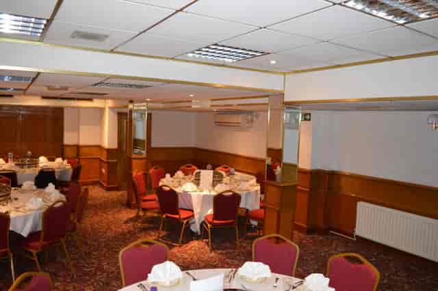 Private dining room with elegant round tables for corporate events and celebrations.