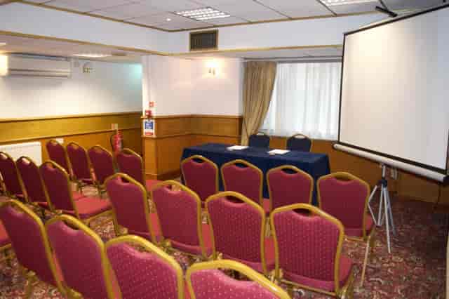 Private dining room with burgundy chairs, perfect for meetings and workshops.