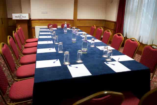 Private dining room setup with long table for professional meetings and workshops.