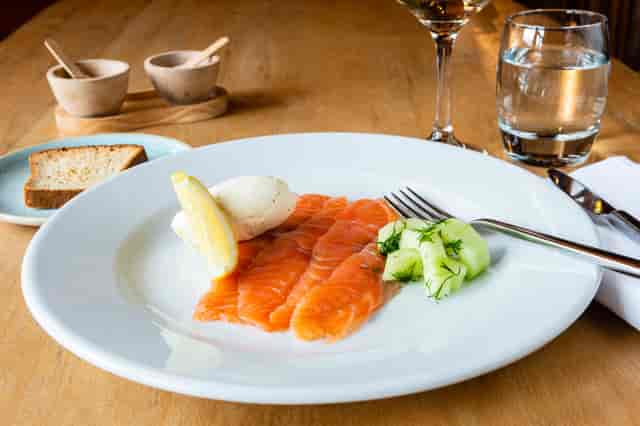 Elegant salmon dish with cucumber and lemon at The Treehouse, Alnwick Garden event catering.