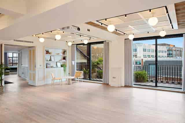 Bright modern event space with large windows for corporate meetings and social gatherings.