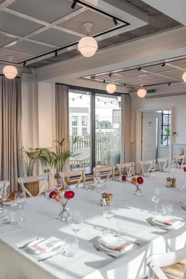 Loft and Gallery event space with elegant table setup for meetings and gatherings.
