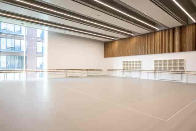 Spacious rehearsal studio with natural light at English National Ballet, ideal for workshops.