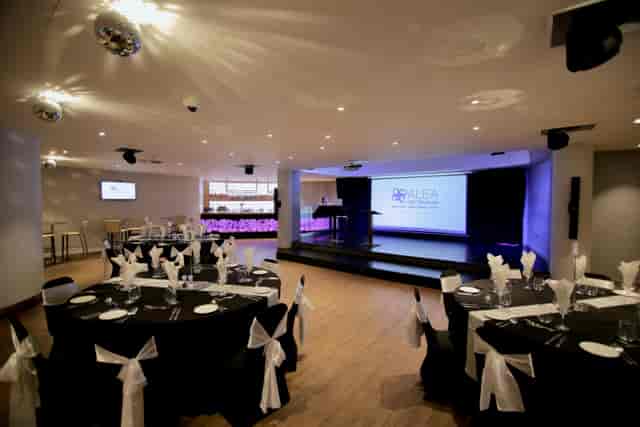 Elegant event space at Alea Casino with round tables, ideal for conferences and celebrations.