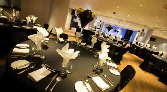 Elegant event space at Alea Casino with black tablecloths for corporate dinners.