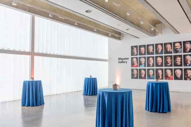 Wigoder Gallery event space with blue tables, ideal for art exhibitions and corporate receptions.