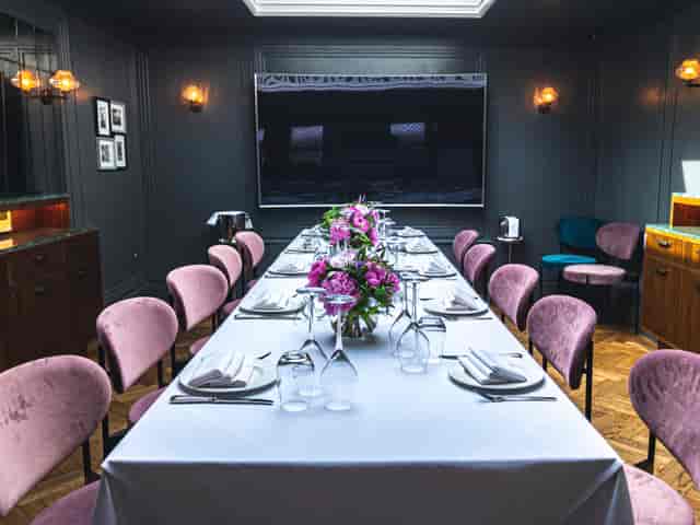 Elegant meeting space with floral centerpiece for corporate events and private dinners.