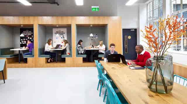 Modern co-working space with cozy booths and natural light for events and networking.