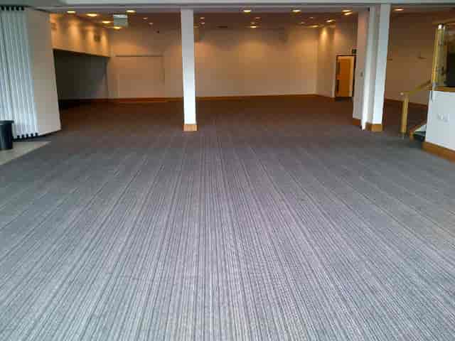 Spacious event venue with oak trees, ideal for conferences and social gatherings.