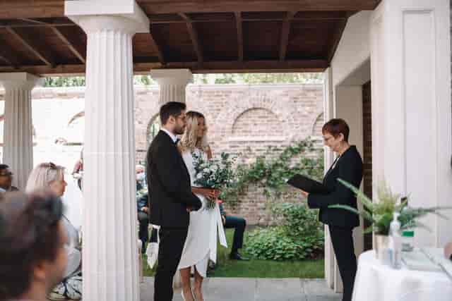 Outdoor wedding ceremony at The Colonnade, Pitzhanger Manor, with elegant columns.