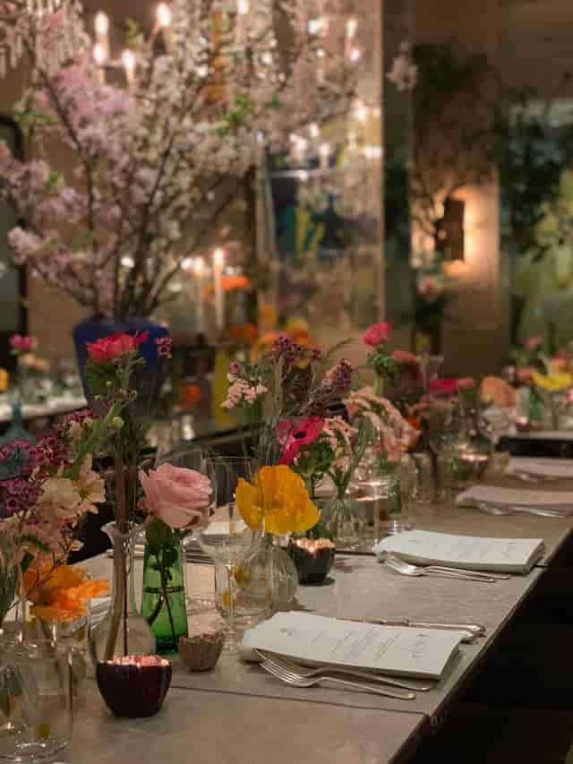 Elegant dining table with floral centerpieces at Petersham Nurseries for upscale events.