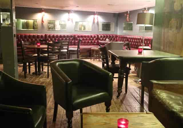 Cozy basement venue with plush seating, ideal for intimate gatherings and cocktail receptions.