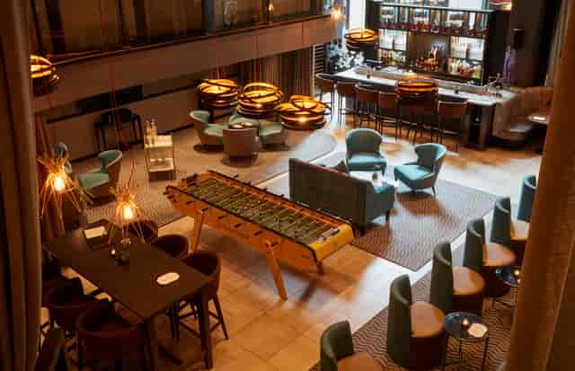 Modern lounge at THE DEN, featuring comfortable seating for networking events and meetings.
