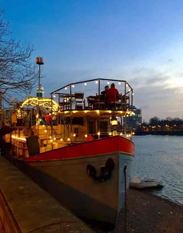 "Outdoor boat venue with twinkling lights for unique events and intimate gatherings."