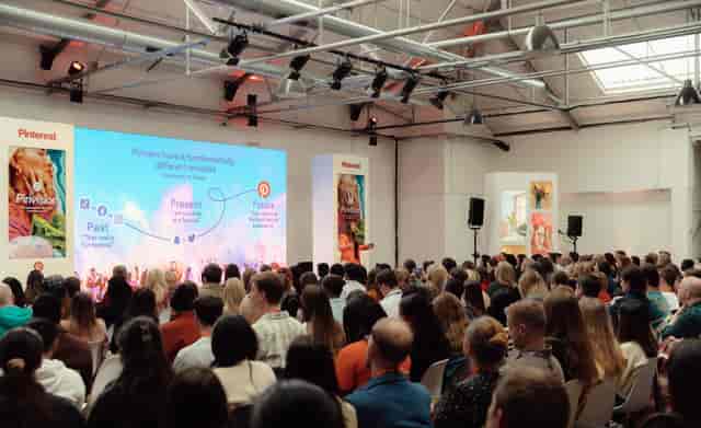 Engaging speaker at a well-attended conference in modern Protein Studios.