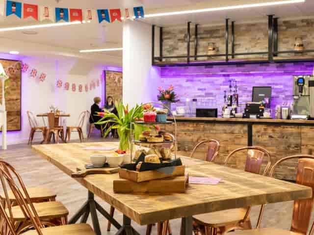 Stylish event space in Smithfield with warm wood accents, perfect for meetings and social events.