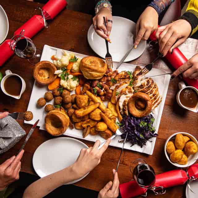 Festive banquet table with hearty dishes at Snug, Punch Tarmey's Liverpool for gatherings.
