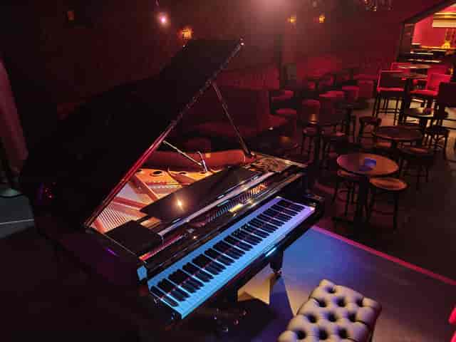 Elegant grand piano stage at Whole Venue, ideal for live performances and upscale events.